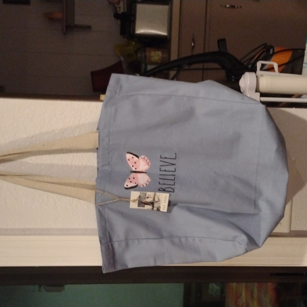 A blue Rae Dunn tote bag